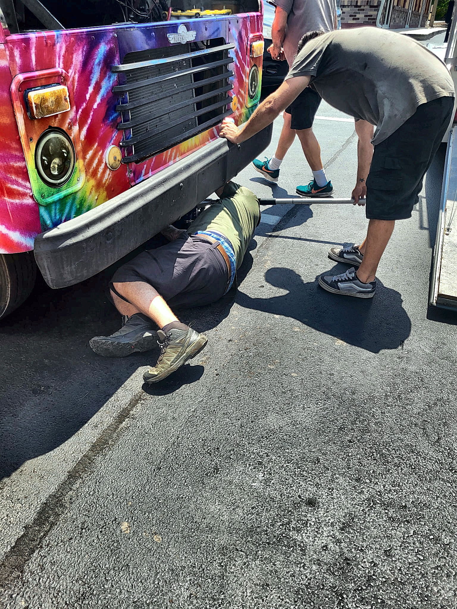 The crew working under a customer's food truck